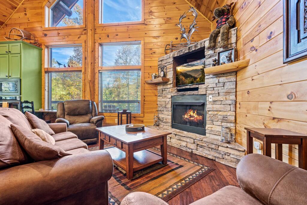 Living room with gas fireplace, cable TV, and comfortable furniture.