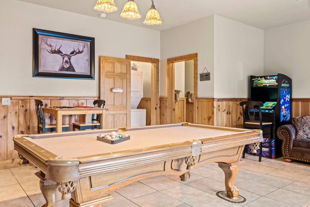 Game room located in the basement featuring pool, games, arcade, and cable TV.