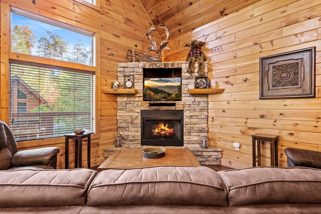 Living room with gas fireplace, cable TV, and comfortable furniture.