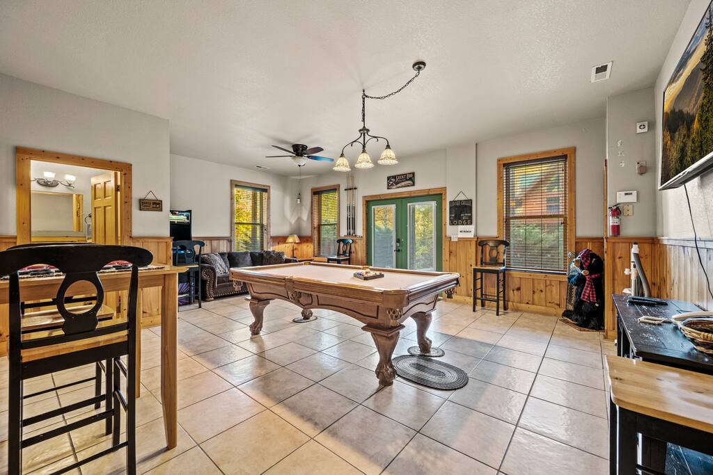 Game room located in the basement featuring pool, games, arcade, and cable TV.