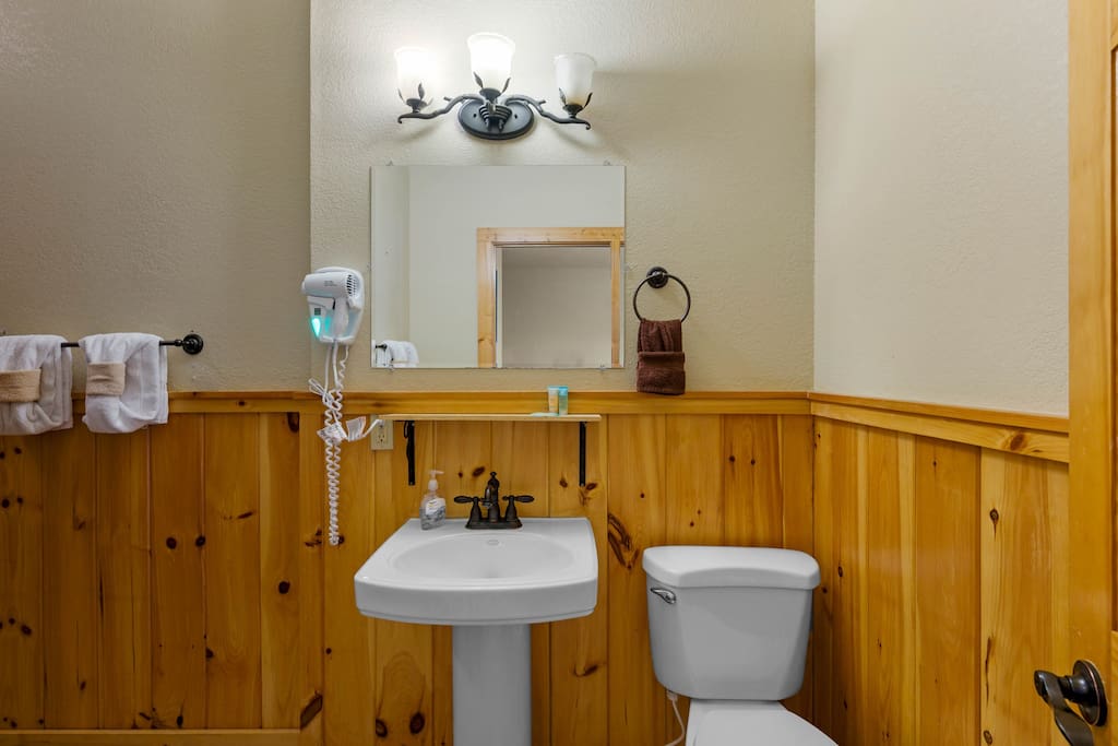 Full bathroom located off game room with shower.