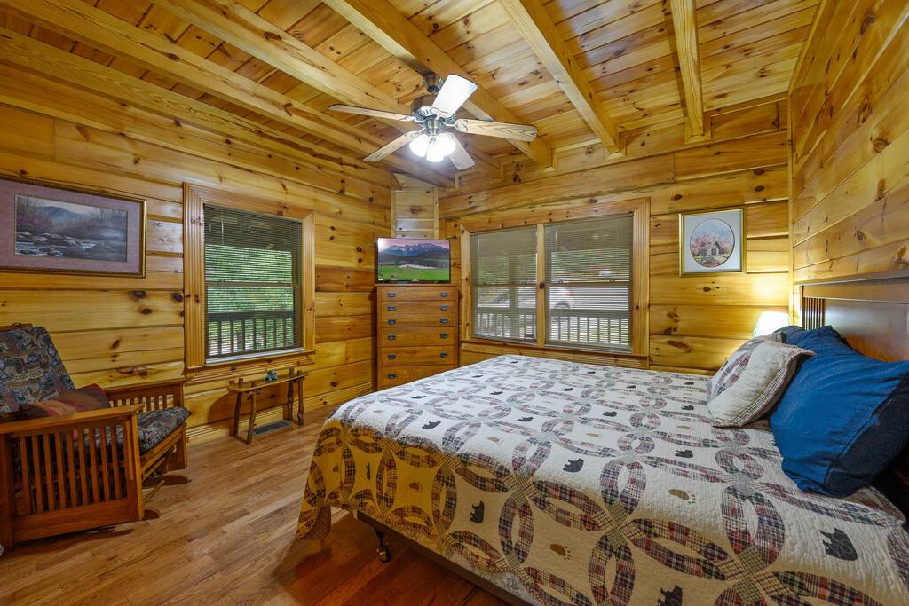 The second downstairs bedroom features a king bed and a rocking chair.