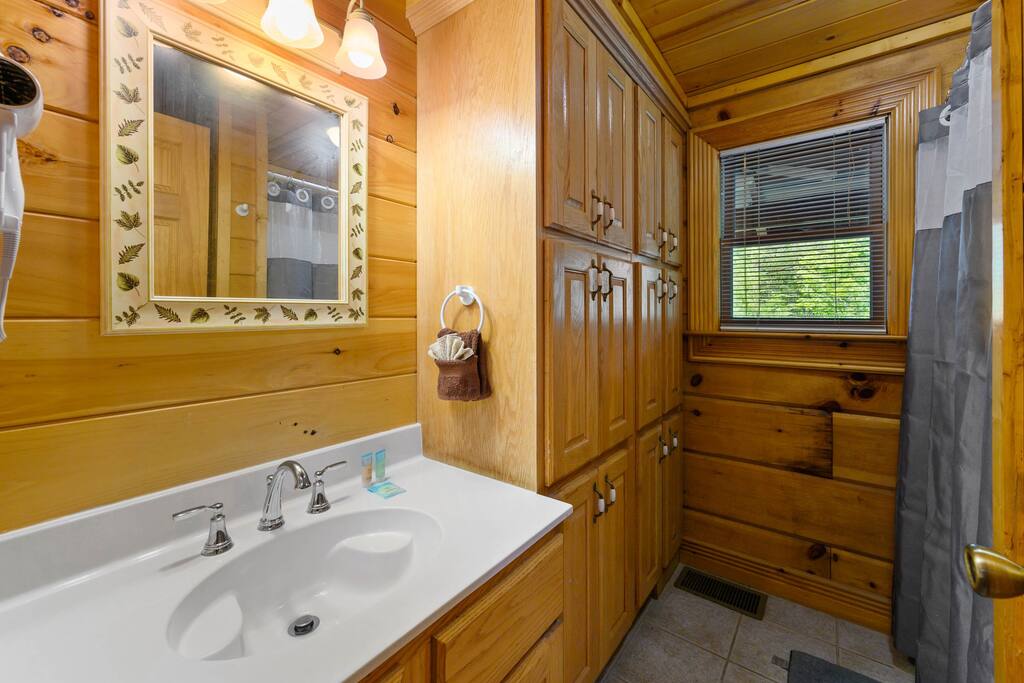 Downstairs bathroom featuring a tub/shower combo.