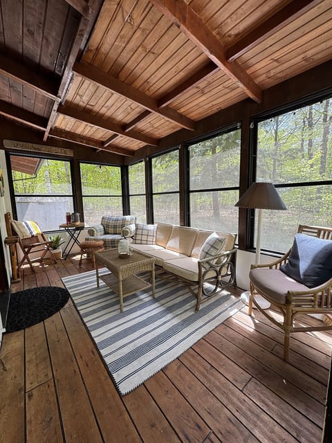 The screened porch offers additional gathering space, the perfect spot to enjoy your morning cup of coffee or sit under the string lights at night.