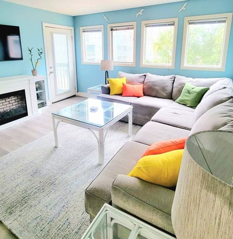 Our open & bright loving room features a large sectional sofa for all your lounging wants & needs