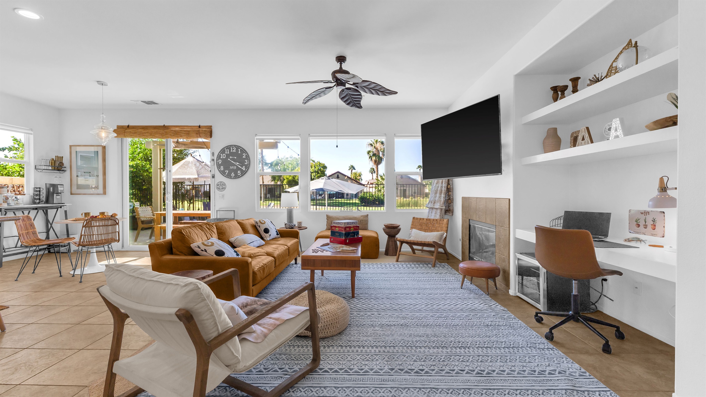 Bright Open-Concept Living Area Relax in style with golf-course views and cozy mid-century décor.