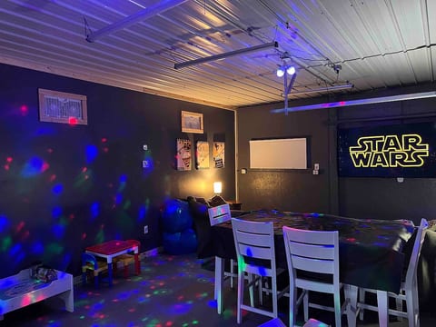 Our Game Room / Theater is perfect for family fun, watching football (or playing football), and relaxing in front of a 75” UHD Roku TV.