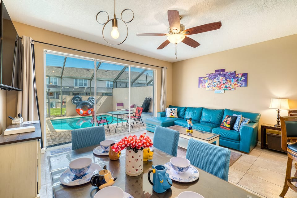 Gather 'round where the magic doesn't end. Our living room is a plush, blue haven for tired theme park legs. Here, every cushion whispers a Disney secret, and every wall tells a story.