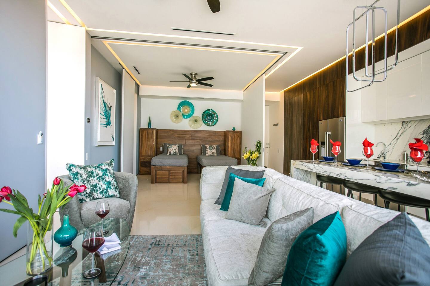 The living room with a view of the guest bedroom with the retractable walls open