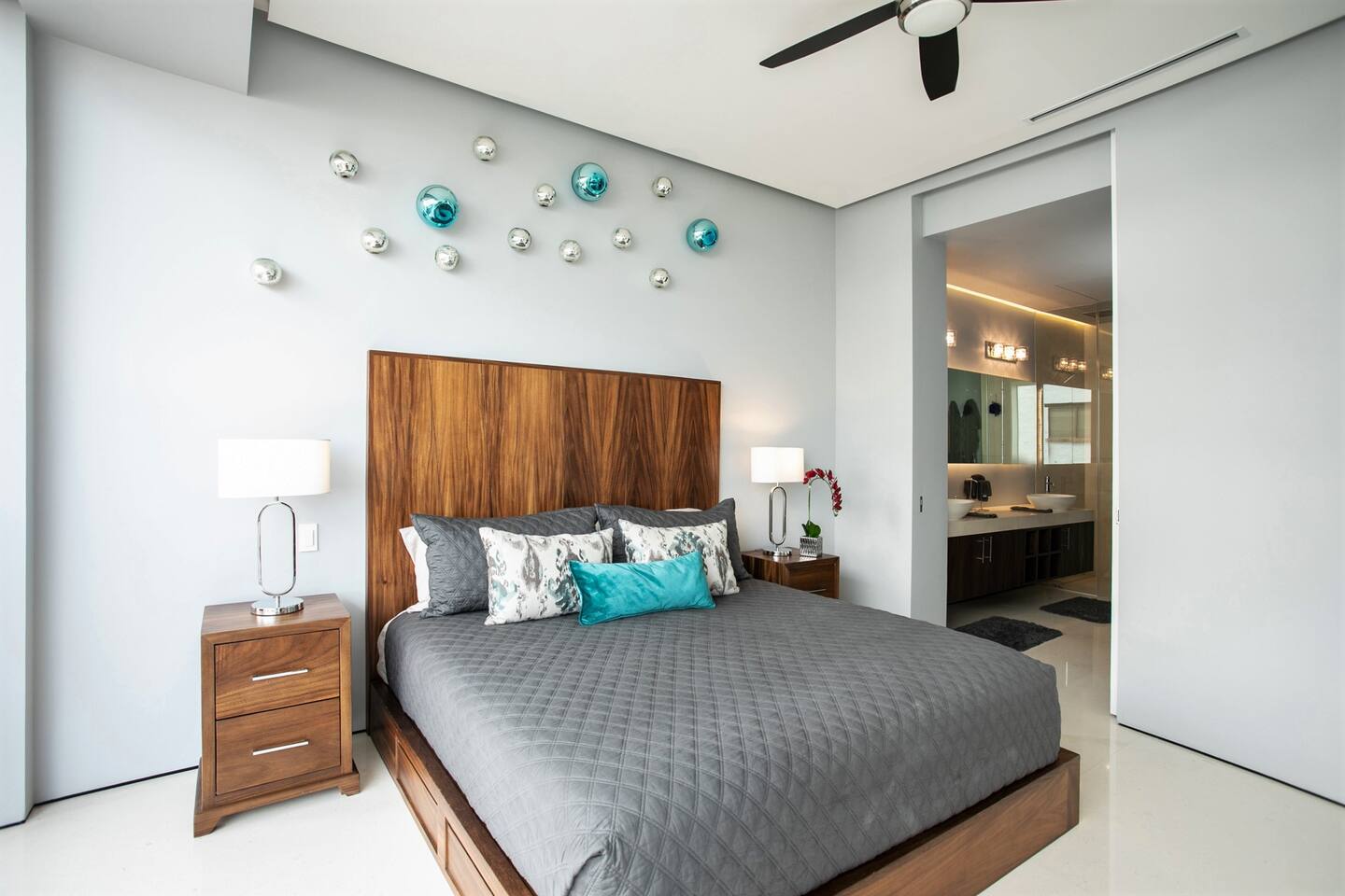 King size bed with Luxury linens & comfortable pillows.  View into Master Bath.