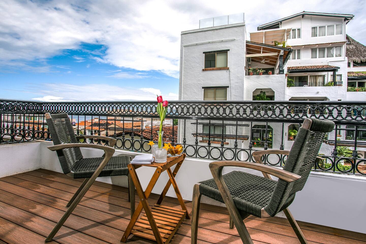 Balcony with comfortable seating and views of the ocean.