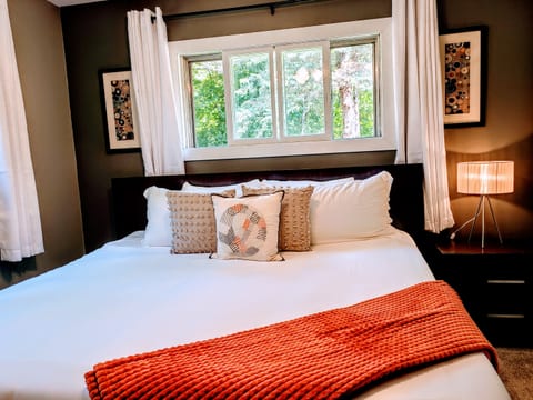 This king room features an ultra-comfortable, cool sleeping latex mattress with luxury bamboo bedding. A ceiling fan, air purifier, and portable A/C unit are provided for added comfort.
