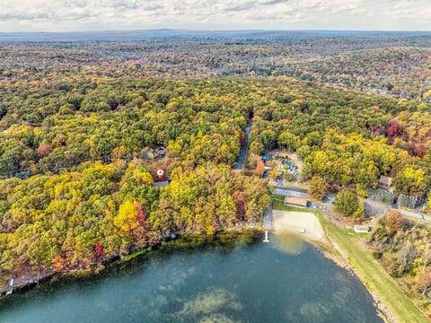 A bird's-eye view of "Olibear Lakefront in the Poconos" - a cozy haven amidst the changing leaves, offering the perfect getaway.