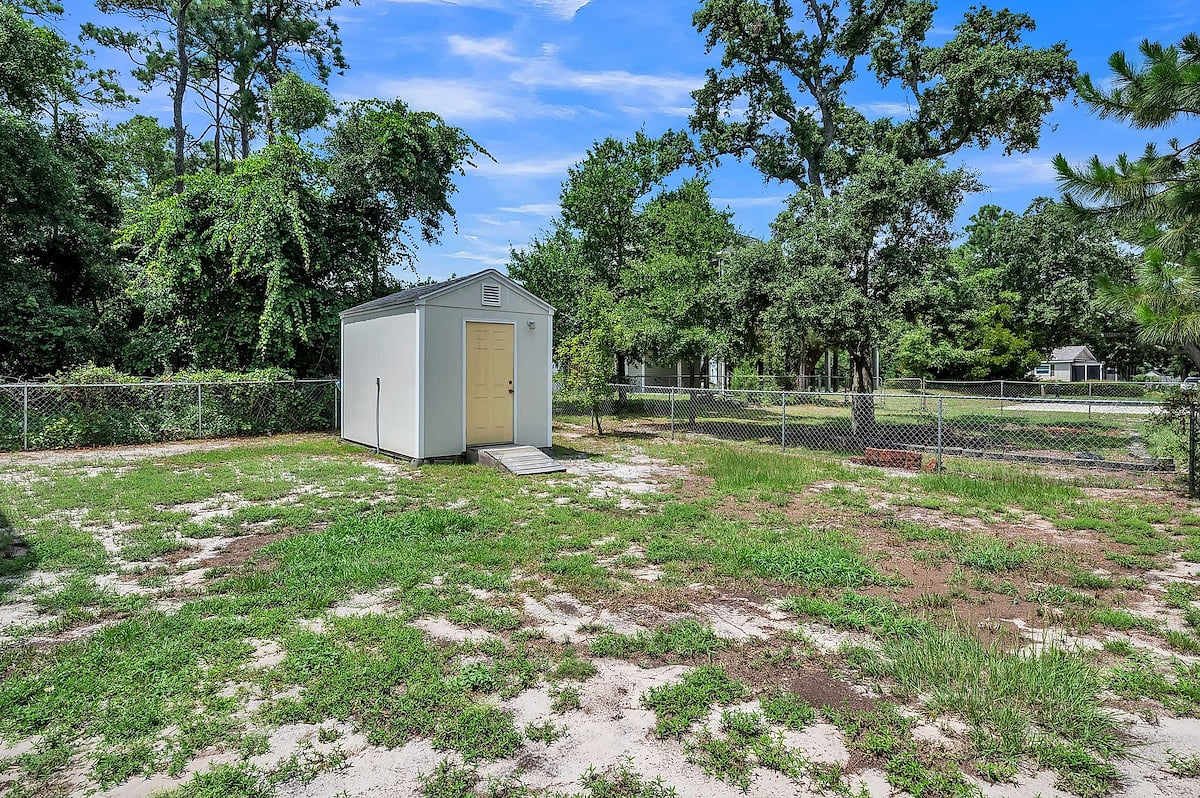 The beach chairs and umbrella will be hanging on the back of the shed.