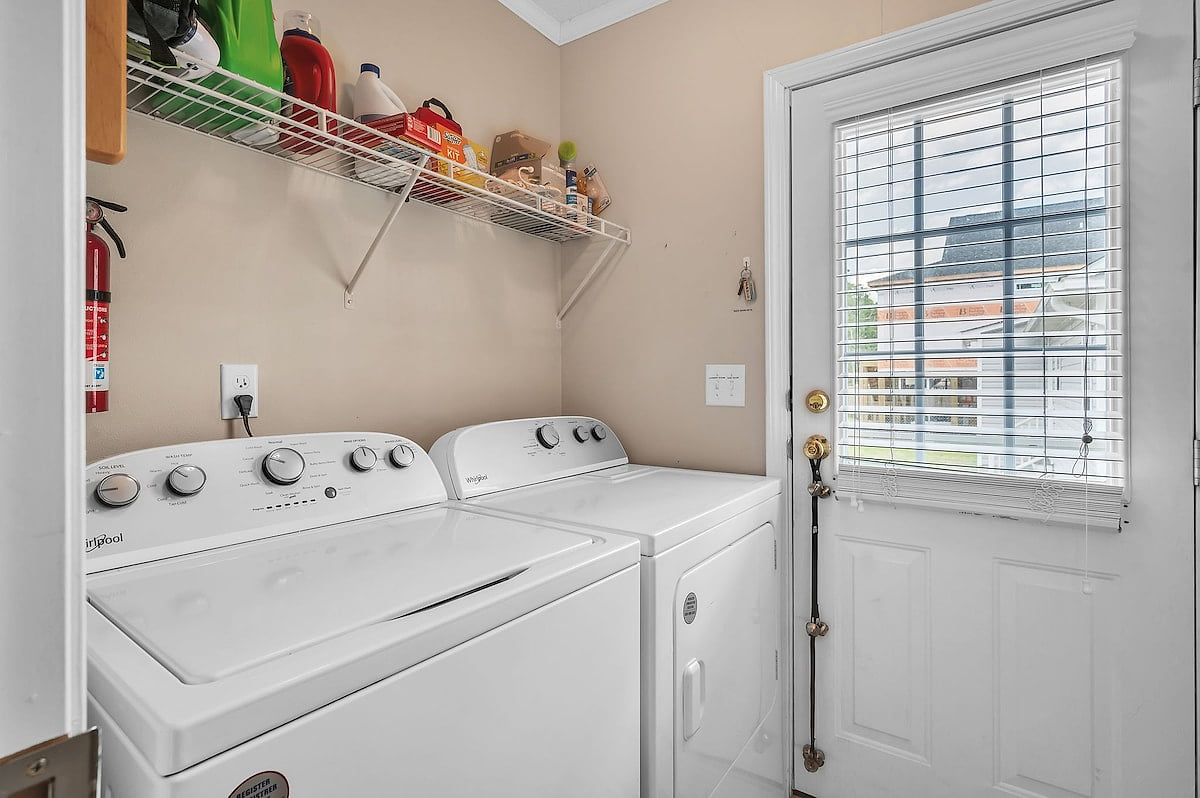 The laundry area contains a washer/dryer purchased in 2023.  The side door is convenient for pets and opens to the fenced-in backyard.