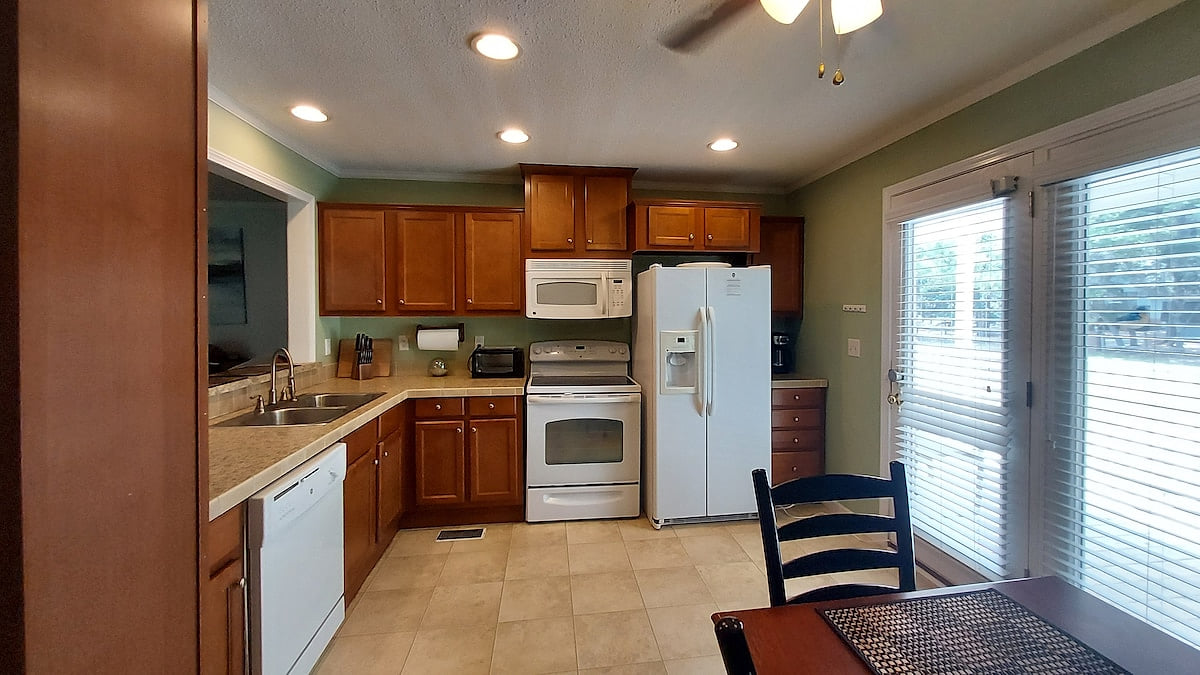 The kitchen includes an oven range, a new microwave, dishwasher and toaster oven with  air fryer.  Also coffee maker and tea kettle.  The drawers and cabinets are well stocked with mugs, glasses, dishes, forks, knives, pots and pans etc.
