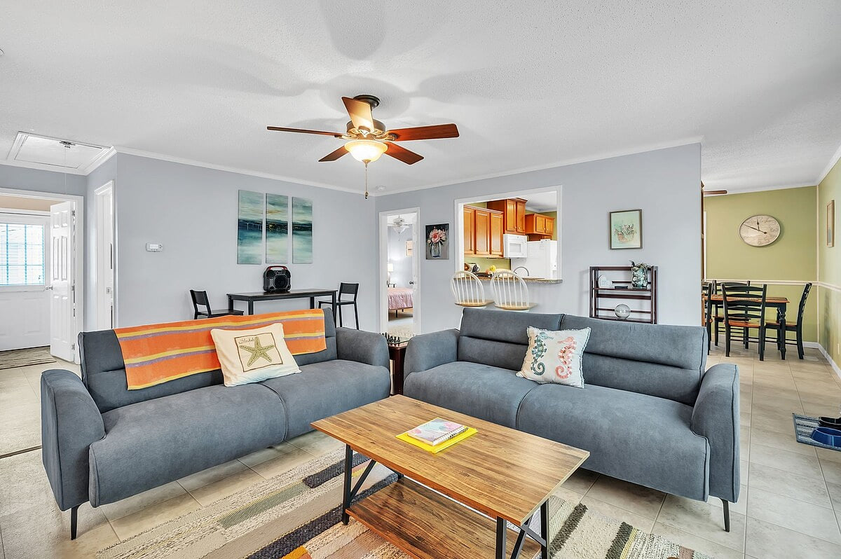 The living room includes two full size couches and one corner chair, with additional seating available at the table and counter.  The high table includes cables for charging iPhone and Android phones. 