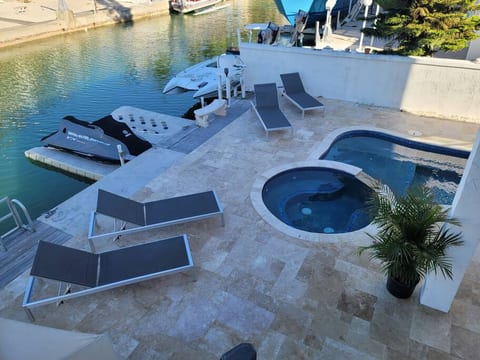 Inground hot tub, floating double jet ski dock.