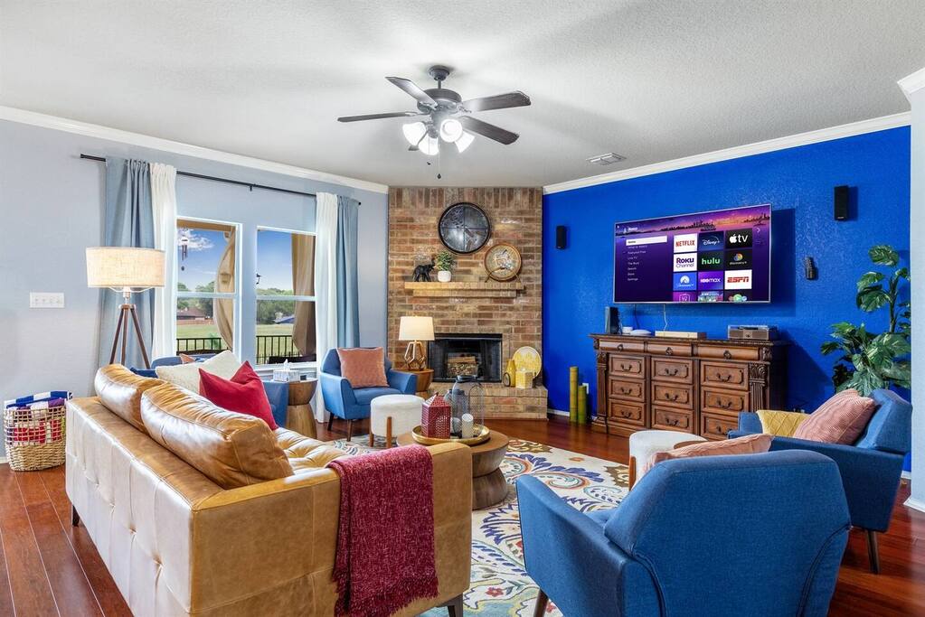 Living room with fireplace, and view of the pool