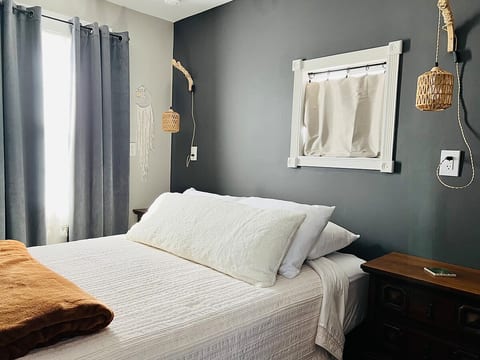 Queen Stearns & Foster bed with a firm mattress in the sleep area. Cool weather bedding includes cotton sheets and a warm duvet with extra blankets. Each side of the bed has a nightstand and power outlets.