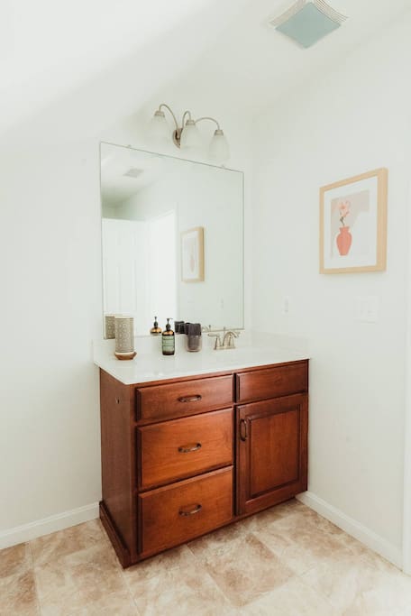 This full bathroom with standing shower is upstairs and shared by the two upstairs bedrooms. 