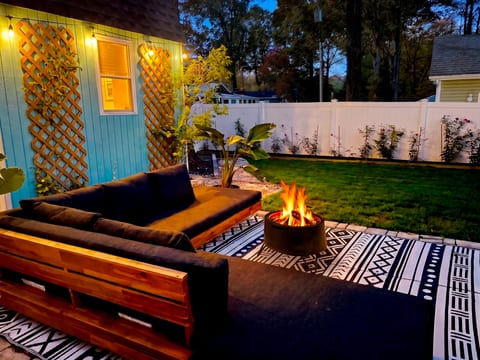 Cozy fire pit patio with private fenced yard and stylish outdoor seating