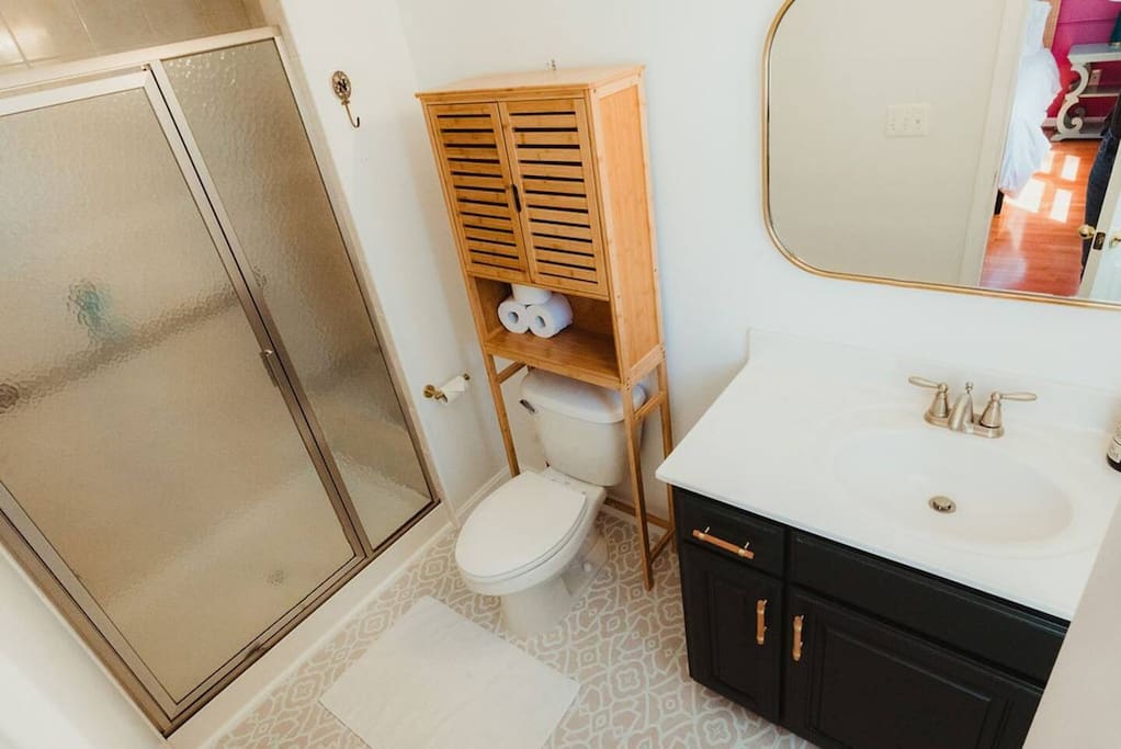 Primary en suite bathroom. The shower has a railing and a bench for those that might be less mobile.