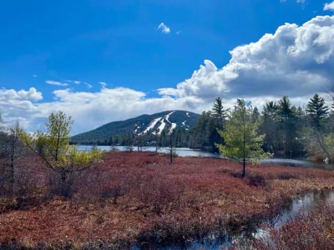 View of Pleasant Mountain/Shawnee Peak from beach area in April 2022