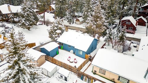 Arial view of chalet covered in snow