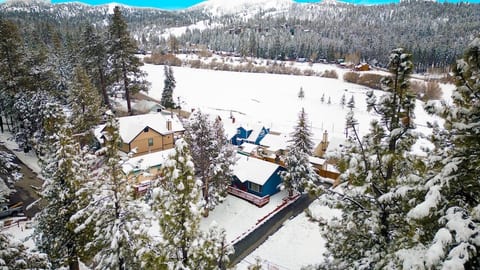 Arial view of chalet covered in snow