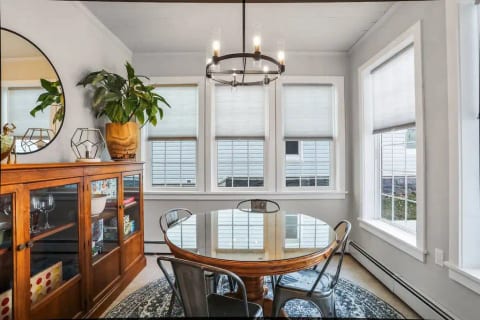 The bright sun room provides the perfect space for playing games, enjoying a meal, and spending time with your people.