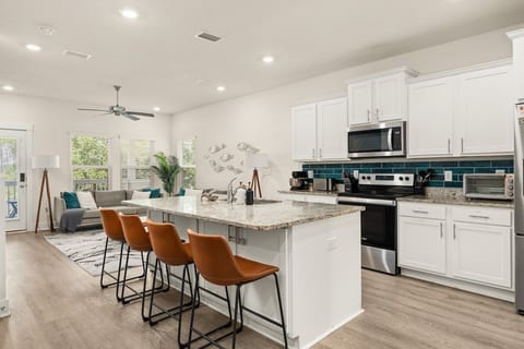 Bright, modern kitchen featuring full-size appliances and ample counter space.
