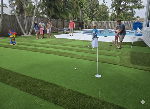 Backyard oasis with pool, private putting green, hammock and palms