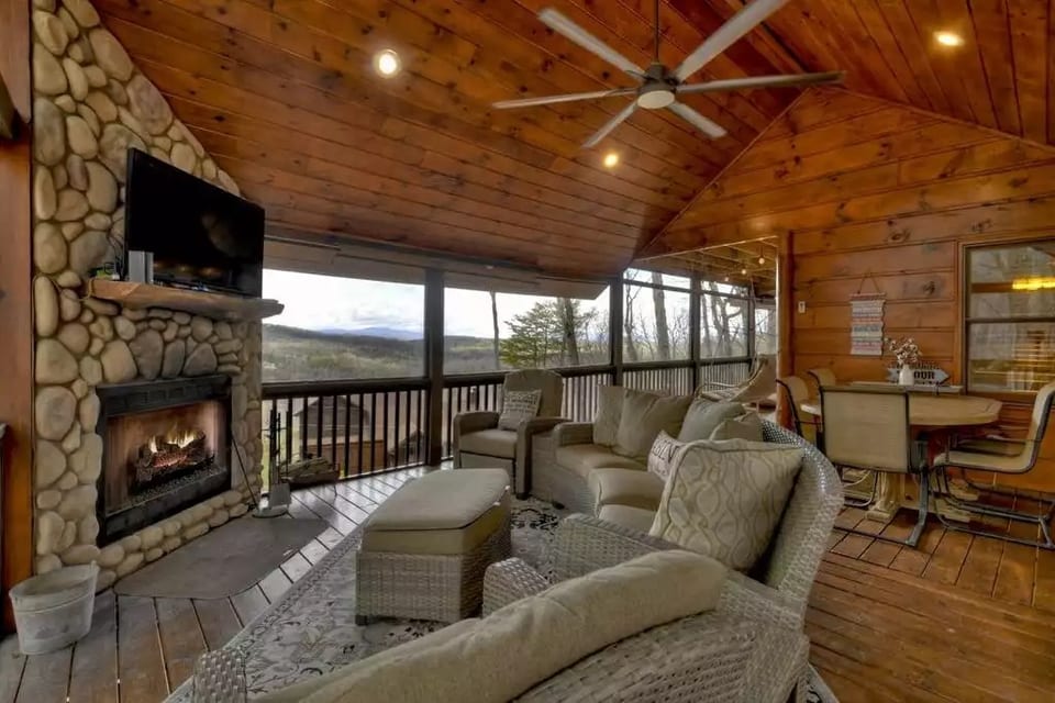 Outdoor living room with seating and eating area.  Wood burning fireplace.