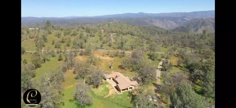 Aerial view of part of this 60-acre property with the ranch house and the dome house on the hill.