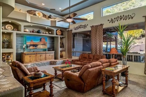 Spacious great room has 14' ceilings and French doors that access the backyard oasis.