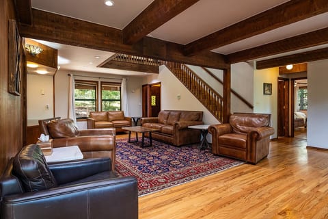 A roomy gathering space with exposed beams, leather seating, and an open layout that gives families and groups a comfortable place to reconnect between mountain adventures.
