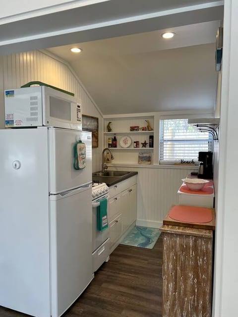 Kitchen has stove, oven, microwave, fridge/freezer, coffee maker, and kitchen items to cook either inside our out!