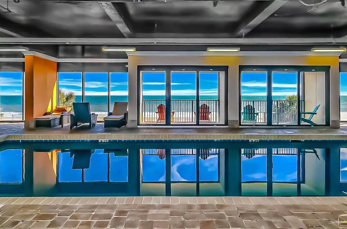 The 2nd floor indoor pool with balcony overlooks the ocean.