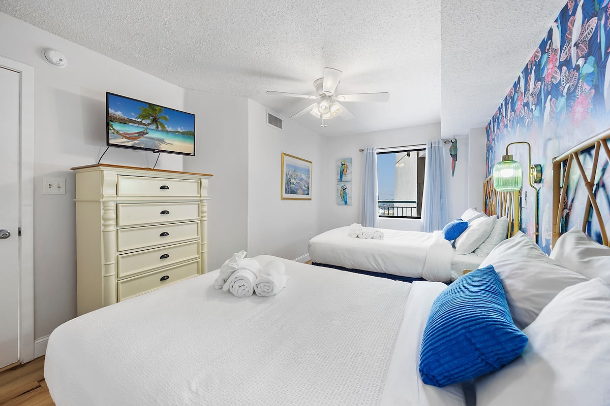 Perfect for families or groups, this room provides two comfortable full beds and ample storage space.