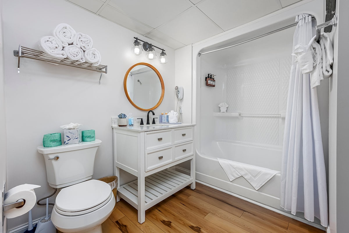  Full bathroom between the kitchen and the first two bedrooms. This newly updated full bathroom features a vanity, sink, mirror, tub, shower, and toilet. You can access this bathroom from the hallway or Bedroom 3.