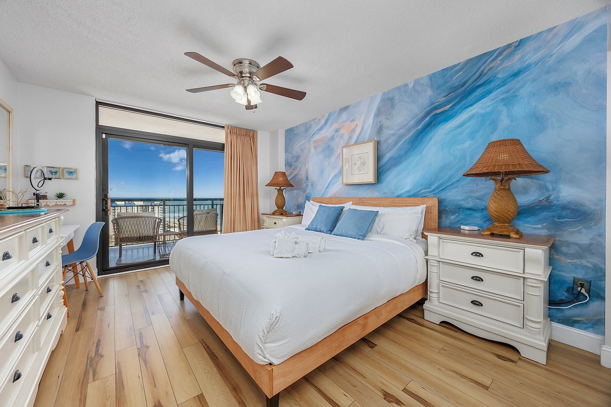 Master Bedroom with King Bed and Balcony Access
Enjoy restful nights in the master suite, offering a plush king-size bed and direct access to the oceanfront balcony.