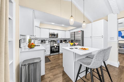 Open-concept kitchen with island seating and plenty of prep space for your group.