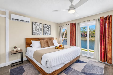 Spacious waterfront bedroom featuring a king bed and beautiful lake views.