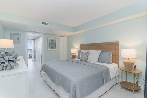 As you enter the unit, you are greeted with the King bed followed by the kitchen & living area.