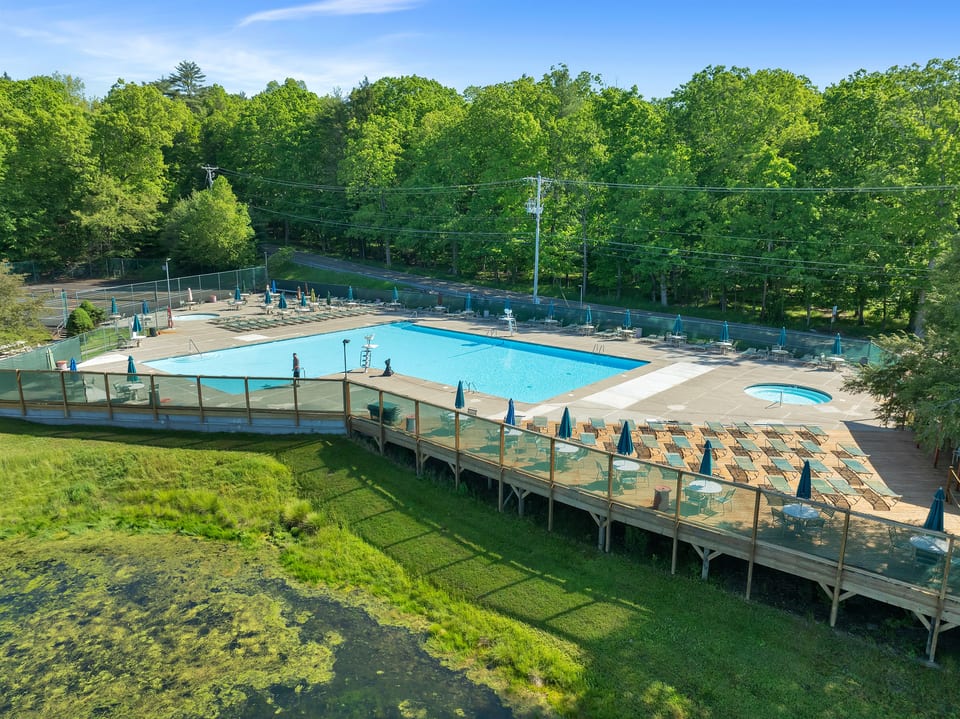 Poolside Paradise! Relax by the pool, soak in the hot tub, and enjoy the scenic pond. Perfect for a refreshing day out!