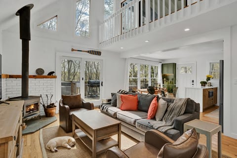 Relax in a lakefront room with fireplace, high ceilings, and big views.
