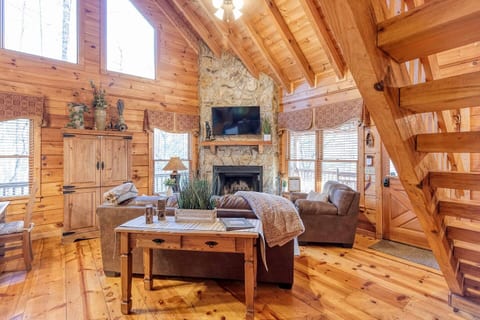 Cozy living room with vaulted ceiling and wood burning fireplace.