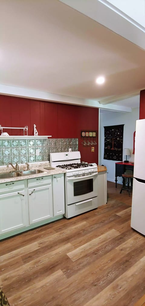 Full kitchen with gas range, microwave, 5 cup drip coffee maker, French Press coffee pot, pots and pans, basic spices.