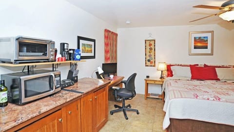 A workdesk and comfortable, adjustable chair are provided, along with an extra monitor.